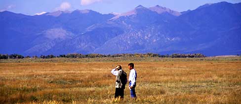 Ranchers from Ecuador meet with TNC conservationists at Medano-Zapata ranch about grassland habitat preservation.